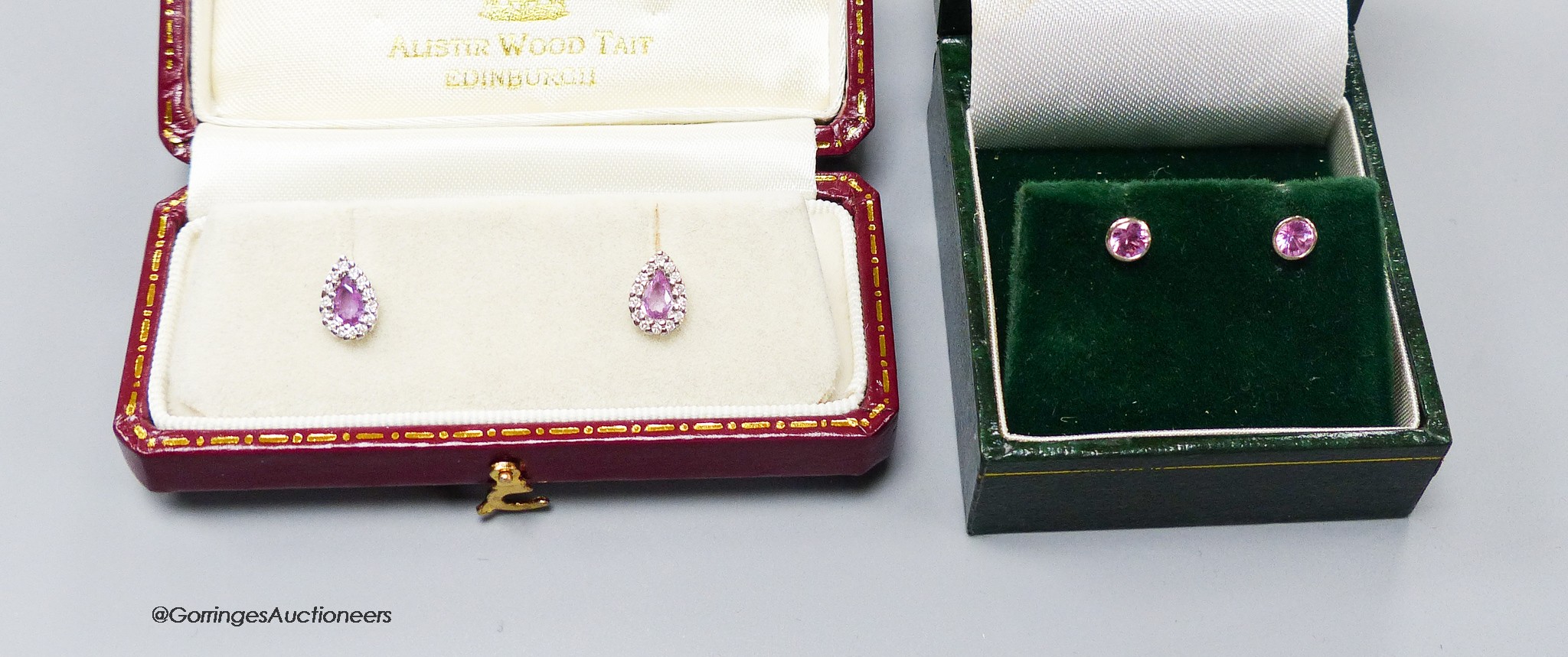 A modern pair of 18ct white gold, pink sapphire and diamond cluster set pear shaped ear studs, 8mm and a pair of 18ct gold and solitaire pink sapphire set ear studs, 4mm, gross weight 2.8 grams.